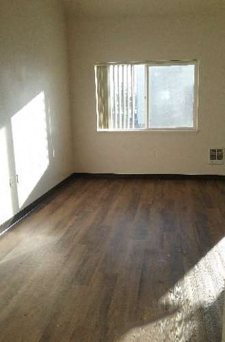 Image of hardwood space with window and wall heater